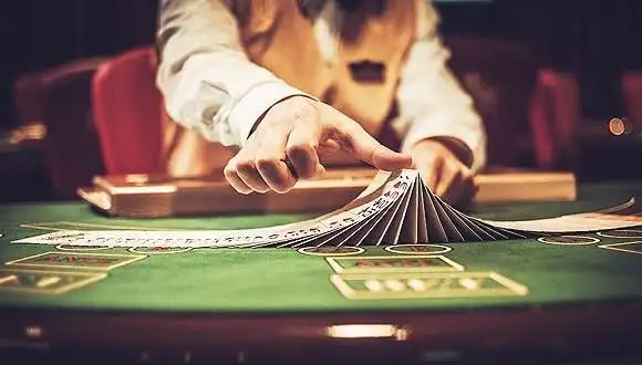 Mobile phone displaying sport betting live blackjack table with roulette wheel and player balance